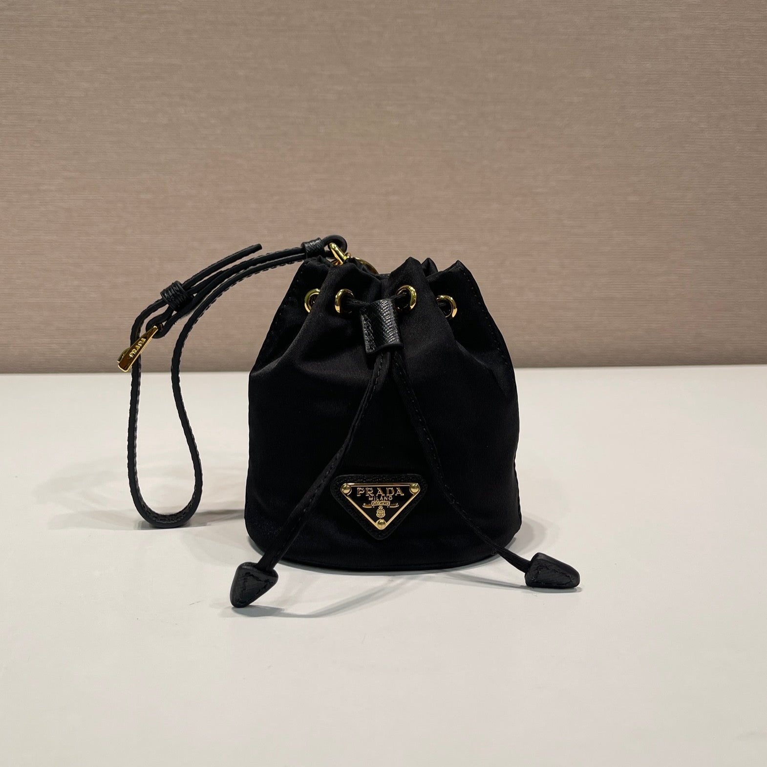 PRADA MINI BUCKET BAG 10 IN BLACK RE-NYLON AND SAFFIANO LEATHER STRAP