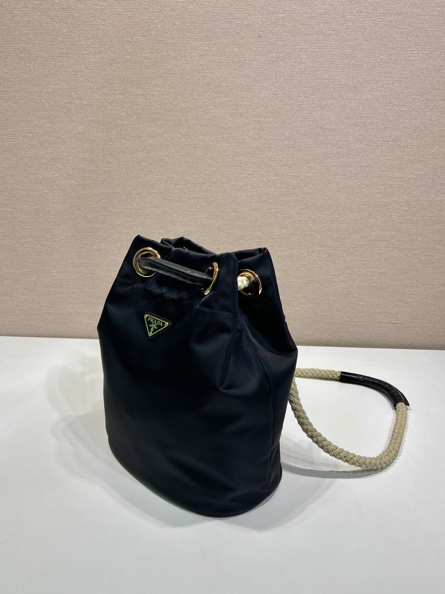 PRADA BUCKET BAG 28 IN BLACK RE-NYLON GOLD LOGO