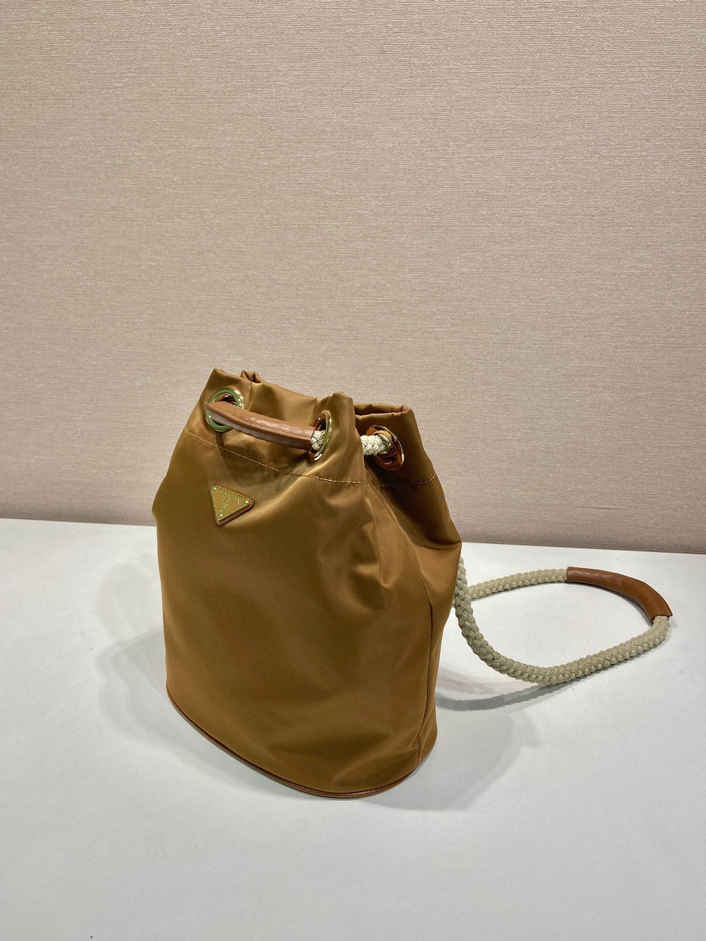 PRADA BUCKET BAG 28 IN SEPIA BROWN RE-NYLON GOLD LOGO