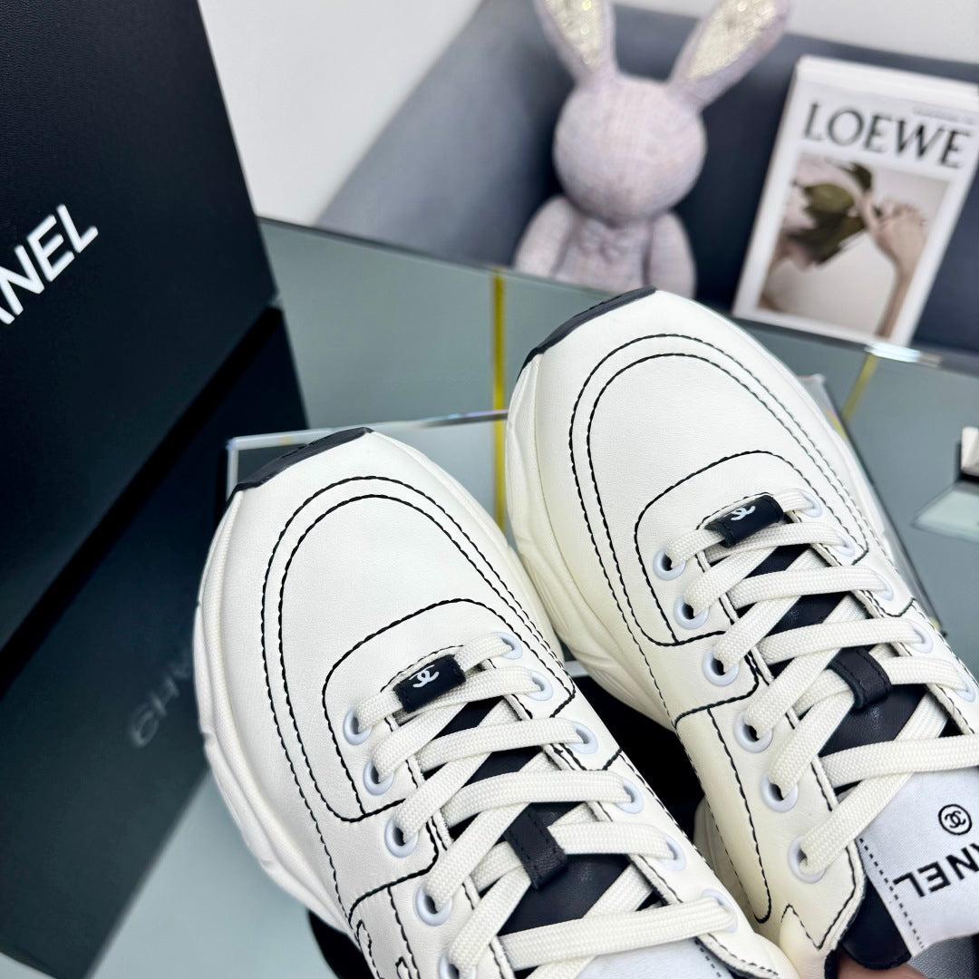CHANEL TRAINERS SNEAKER IN WHITE CALFSKIN WITH BLACK EMBROIDERED