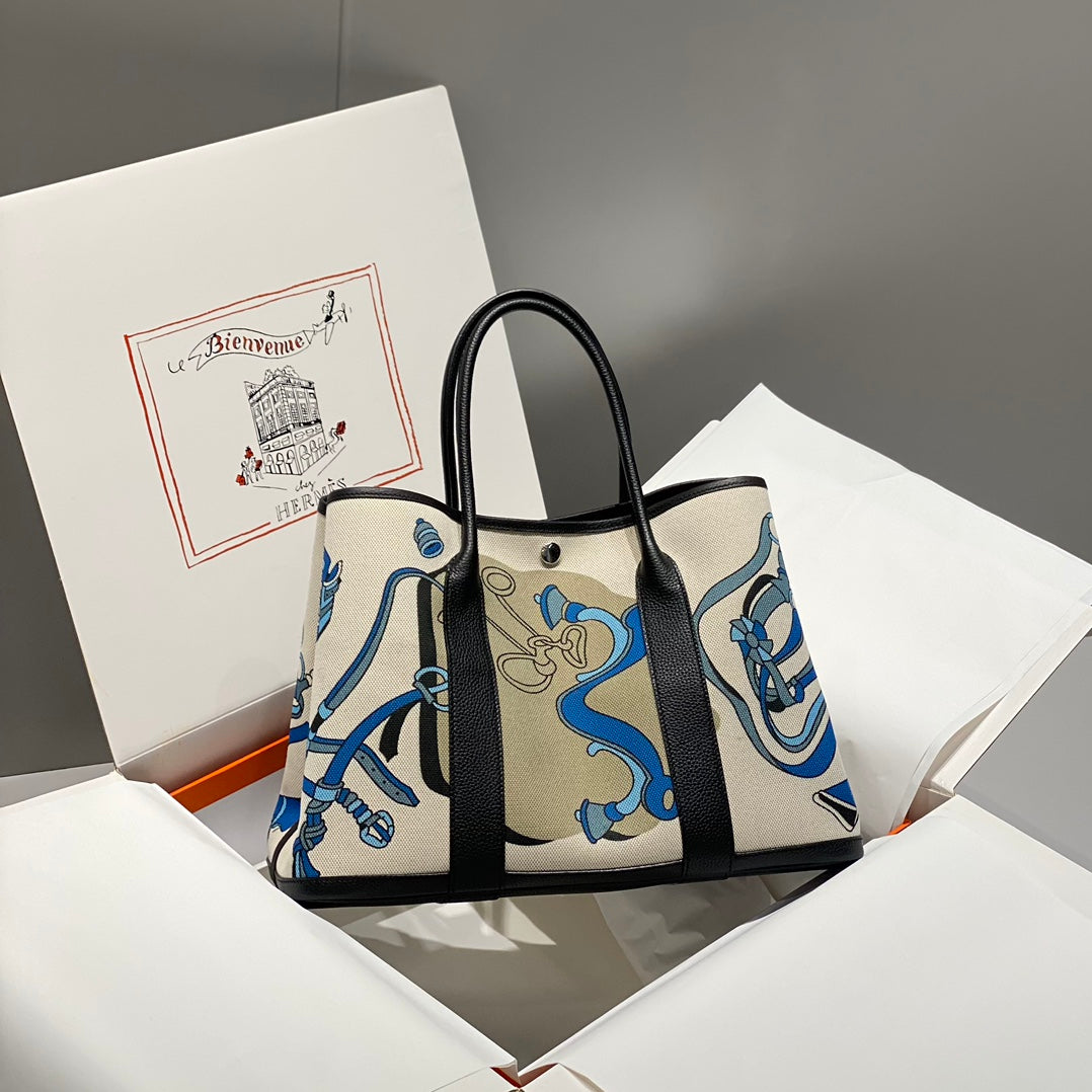 HERMES GARDEN PARTY 36 IN BLUE IVORY TOILE H CANVAS BLACK CALFSKIN EQUESTRIAN HARNESS PRINT