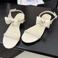 CHANEL FLAT SANDALS IN WHITE CALFSKIN WITH BOW