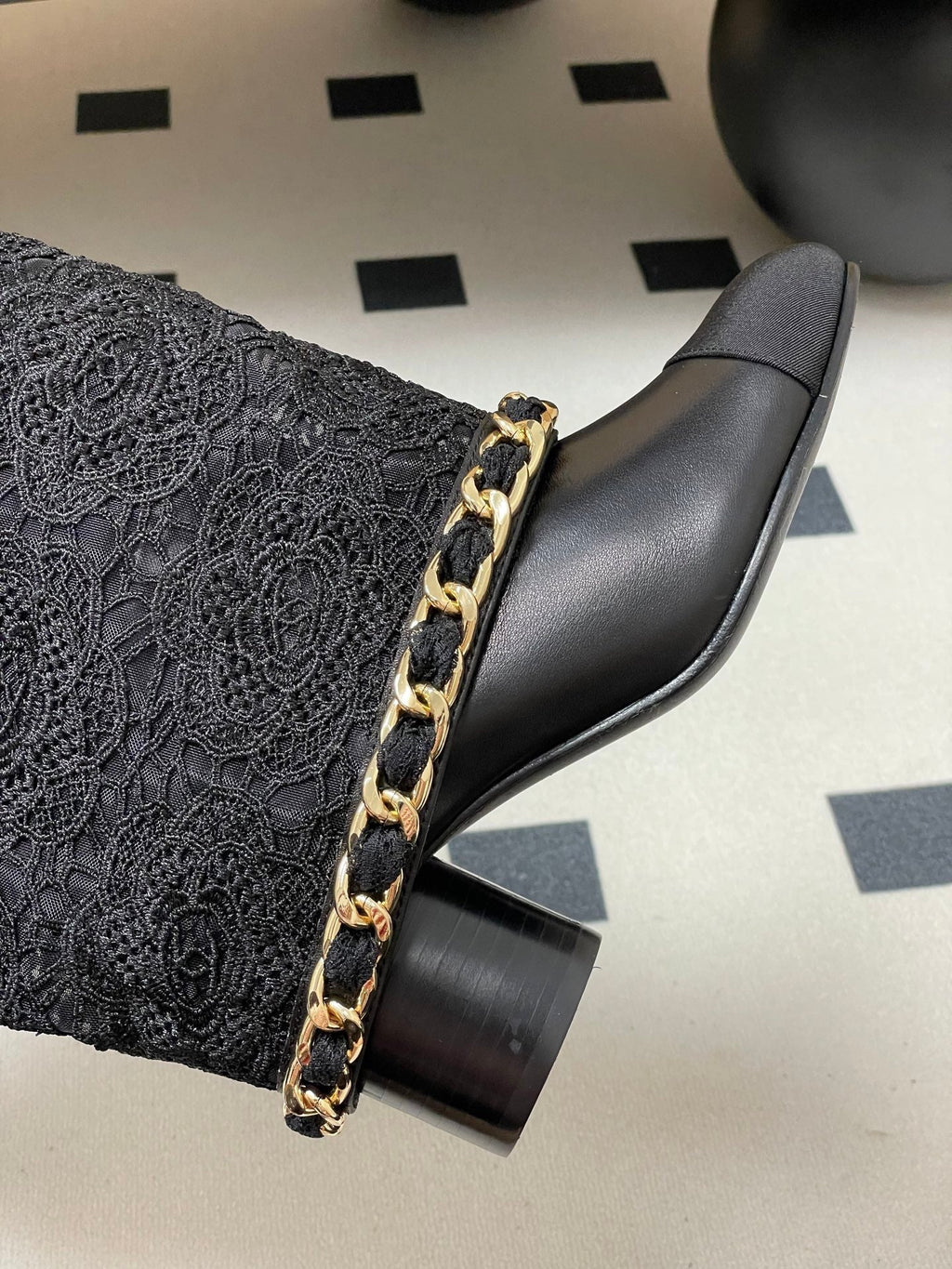 CHANEL FLORAL BOOTS 60MM IN BLACK CALFSKIN WITH GOLD CHAIN